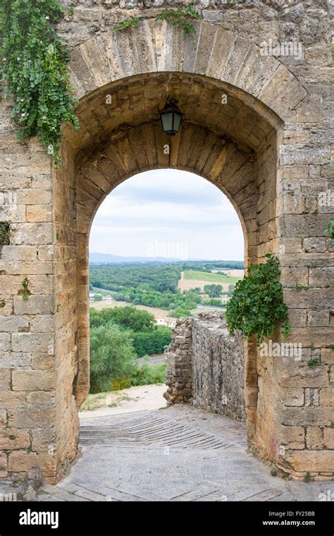 Arched Doorway In A Medieval Stone Wall In The Tuscan Village Of