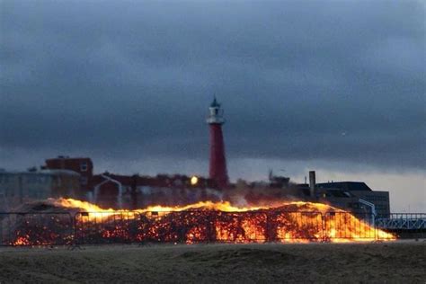 a lighthouse on fire in front of a building
