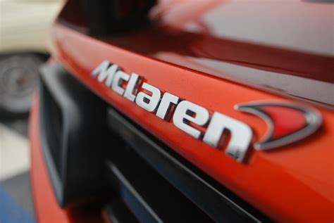 Closeup Of The Emblem On An Orange Sports Car