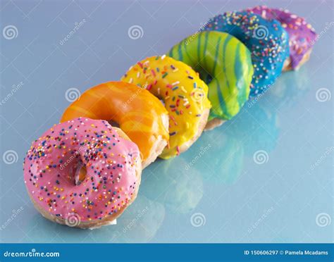Line Of Rainbow Colored Glazed Donuts Stock Image Image Of Colorful