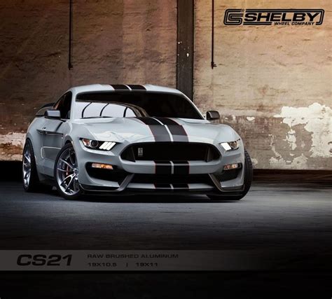 The Front End Of A Silver Mustang With Black And White Stripes