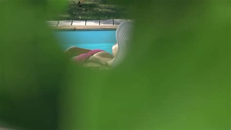 Stalker Spying And Filming An Unaware Girl Sun Tanning In A Pink Bikini