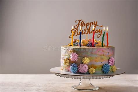Delicious Birthday Cake With Candles On Table Against Grey Background