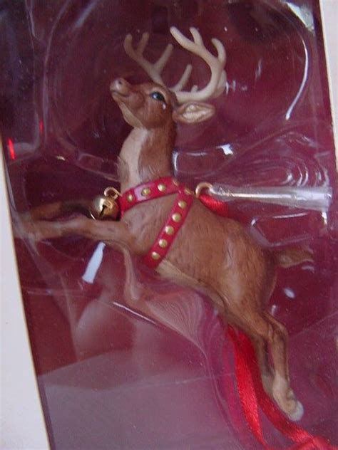 A Toy Reindeer Is In Its Package With A Red Ribbon Around Its Neck