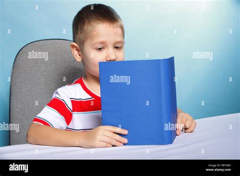 Child Boy Kid Reading A Book On Blue Stock Photo Alamy