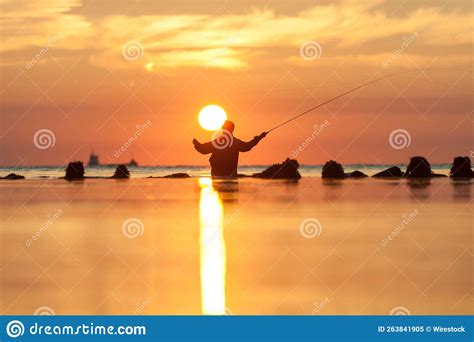 Rear View Of Man Fishing In Sea At Sunset Stock Image Image Of