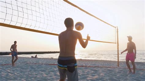 Group Of People Playing Beach Volleyball During Sunrise Or Sunset Stock Video Footage 0017 Sbv