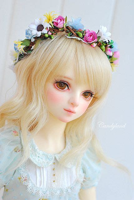 A Doll With Blonde Hair Wearing A Flower Crown