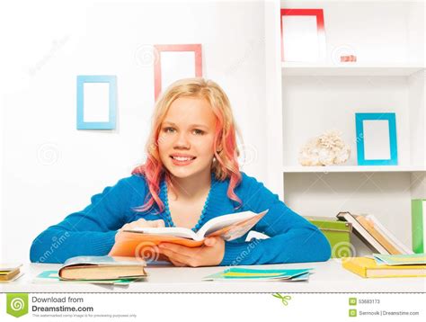 Smart Teen Girl With Books And Textbooks On Table Stock