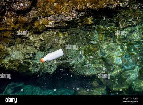 From Above Plastic Bottle Floating In Water Polluting Environment Stock