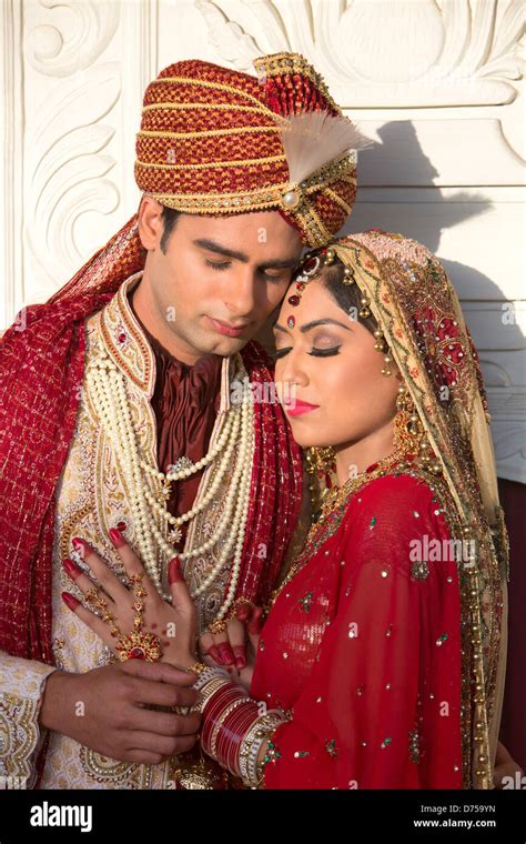 Indian Bride And Groom In Traditional Wedding Dress And Hugging Stock
