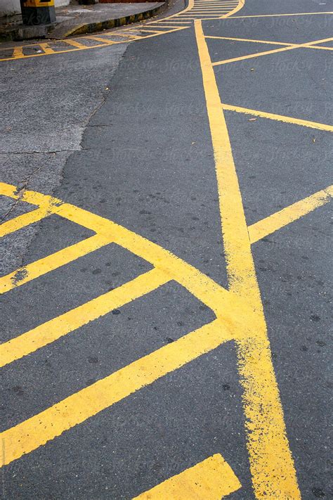 Yellow Painted Road Markings On An Intersection By Stocksy