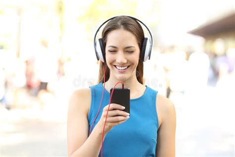Front View Of A Girl Listening To Music On The Street Stock Image