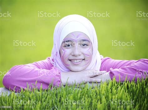 Beautiful Teenage Arabic Girl Lying On Green Grass In Nature Stock