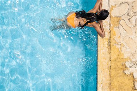 Premium Photo Woman In Bikini Enjoying A Sunny Summer Swimming Pool