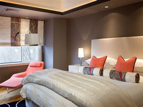 Primary bedroom with orange walls and a tray ceiling, along with tiles flooring. Liv.Luv.Design: Color Palette: Gray and Orange Bedrooms