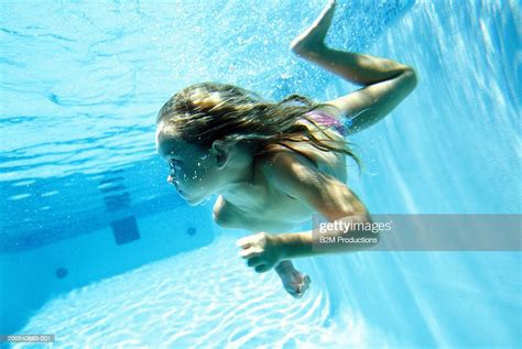 Teenage Girl Swimming Underwater In Swimming Pool Photo Getty Images