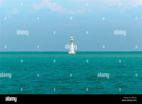 White Lighthouse In The Middle Of The Sea Lighthouse Surrounded By