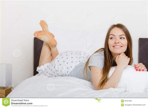 cheerful girl rolling in bed stock image image of couch female 93161833