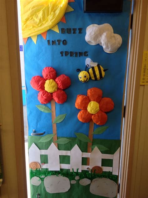 A Door Decorated With Paper Flowers And Bees In The Grass Next To A