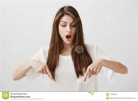 Girl Is Amazed Standing On Transparent Floor Portrait Of Overwhelmed Attractive Woman Pointing