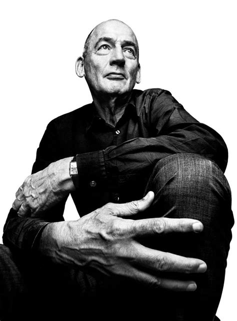 Black And White Photograph Of An Older Man Holding His Hands Out To The Side While Sitting Down