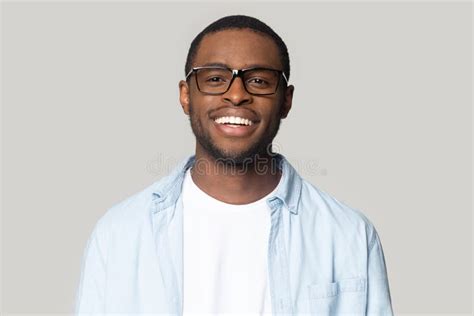 Portrait Of Smiling Black Man In Glasses Isolated In Studio Stock Photo