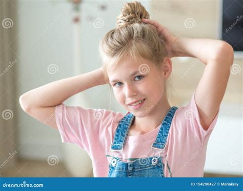 Portrait Of Blonde Pre Teenage Girl Sitting On Couch Stock Image