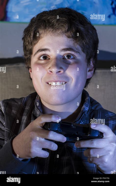 Teenage Boy With Joystick Playing Computer Game At Home Stock Photo