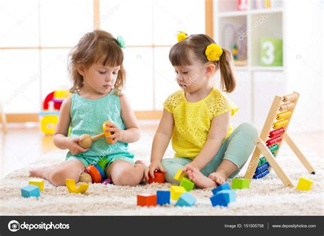 Children Playing Together With Building Blocks Educational Toys For