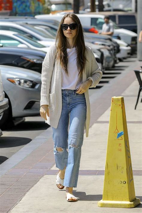 Lily Collins Looks Casual In An Off White Sweater And Ripped Jeans As