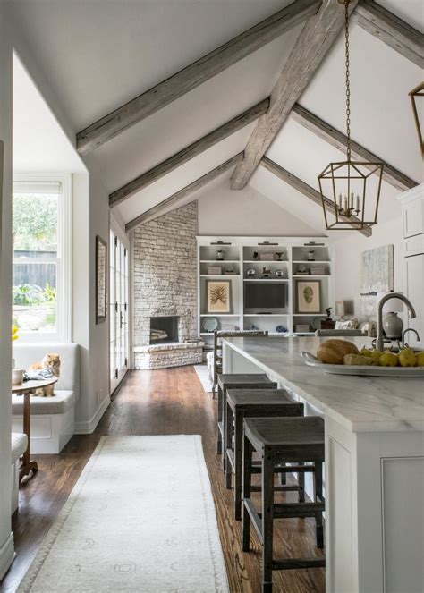 When choosing shades, keep in mind lighter colors enlarge a space. White Cottage Open Plan Kitchen With Vaulted Ceiling | HGTV