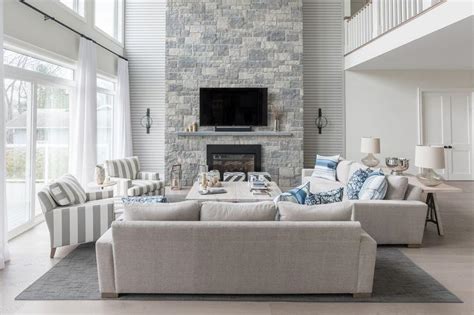 Whether you want to keep your remote, snacks or a book, an end table is super handy. Blue and Gray Living Room with a Two Story Stone Fireplace ...
