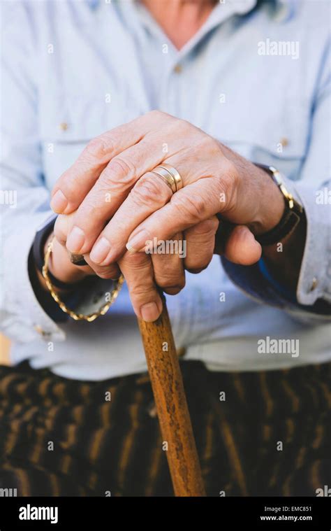 Close Up Of Old Mans Hands Resting On A Cane Stock Photo Alamy