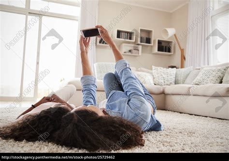 Mother And Babe Lying On Rug And Posing For Selfie Stock Image PantherMedia