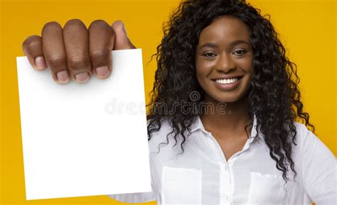 African American Female Holding Blank Card Standing Over Yellow