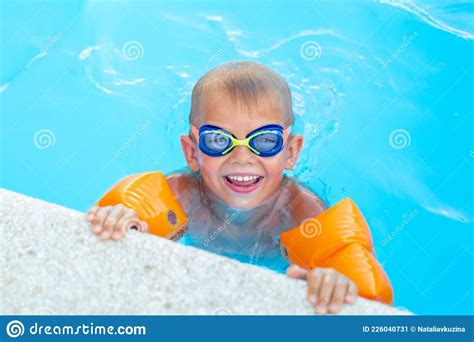 Portrait Smiling Boy In Swimming Pool Child In Swimming Glasses And
