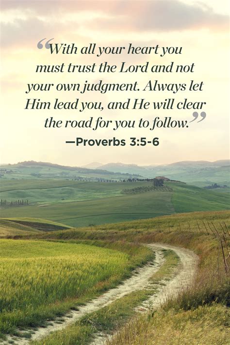 A Dirt Road Leading Through A Field With A Bible Verse Written On The