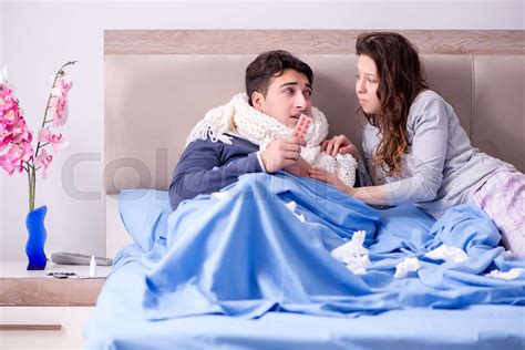 Wife Caring For Sick Husband At Home In Bed Stock Image Colourbox