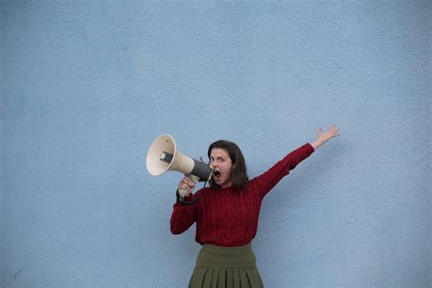Cheerful Young Women Screaming Into Loudspeaker · Free Stock Photo