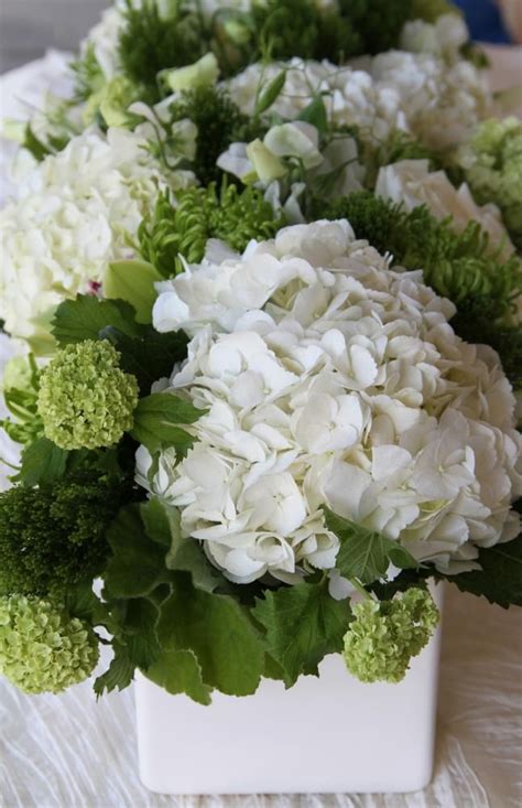 Flowered centerpieces on multiple settings. Simply green and white reception wedding flowers, wedding ...