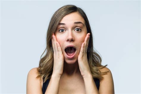 Surprised Young Woman Screaming And Putting Her Hands On Her Head Looking At Camera Isolated On