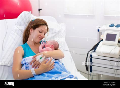 Mother Giving Birth To A Baby Newborn Baby In Delivery Room Mom