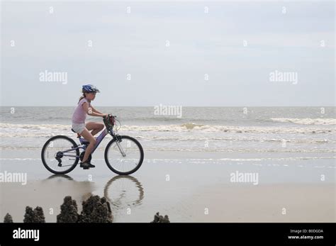Little Girl Rides Her Bicycle On Hunting Island Beach In South Carolina