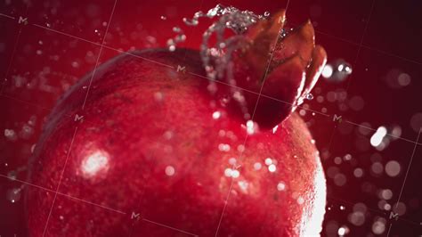 Super Slow Motion Water Drips On Rotating Pomegranate On A Black