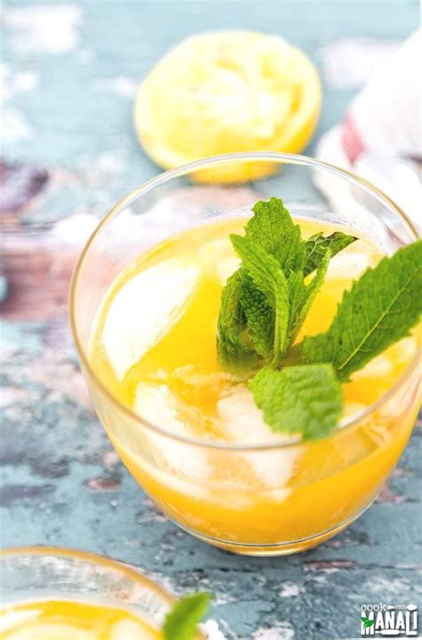 A Glass Filled With Lemonade And Mint Garnish