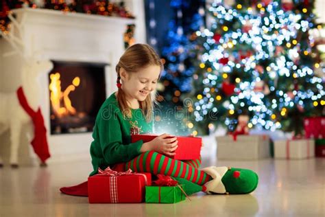 Kids At Christmas Tree Children Open Presents Stock Photo Image Of