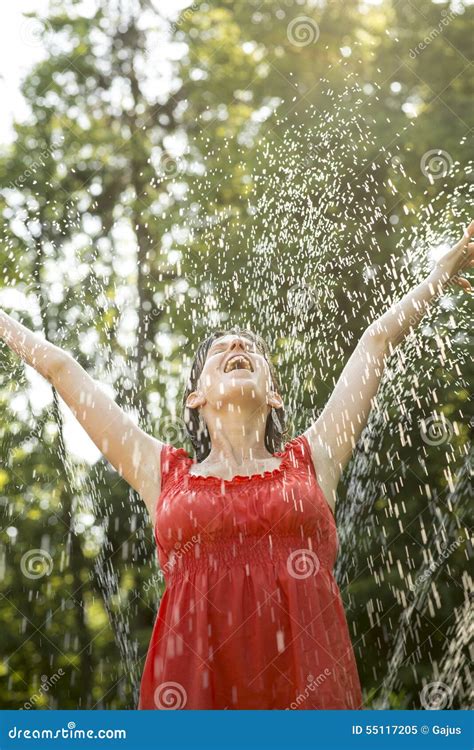 Laughing Woman Standing Under A Spray Of Water Stock Image Image Of