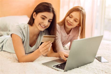 Pleasant Sisters Doing Online Shopping Together Stock Photo Image Of