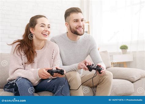 Happy Couple Playing Video Games And Having Fun Together Stock Photo